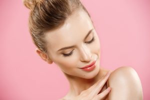 Beauty Concept - Close up Portrait of attractive caucasian girl with beauty natural skin isolated on pink background with copy space.